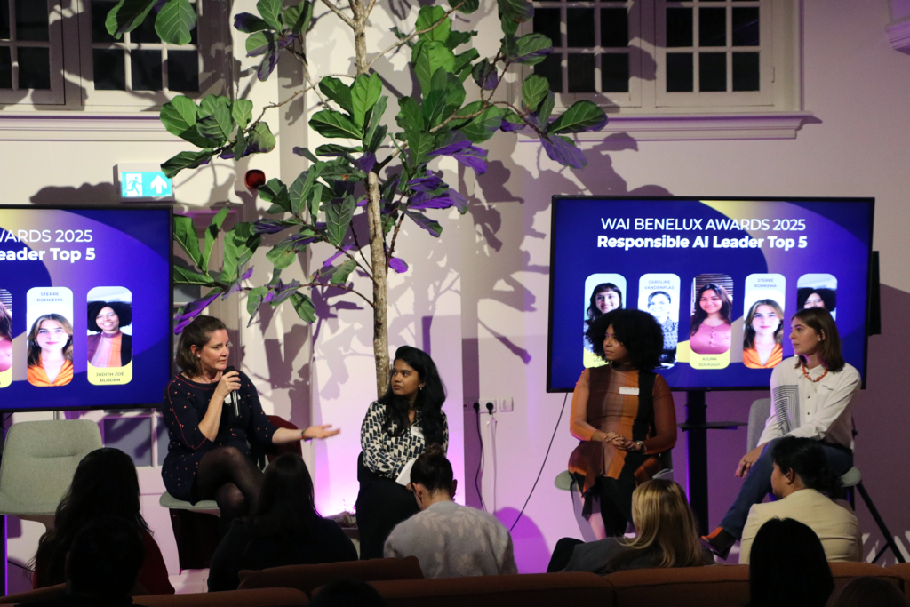group of women on a stage talking about sustainability in AI