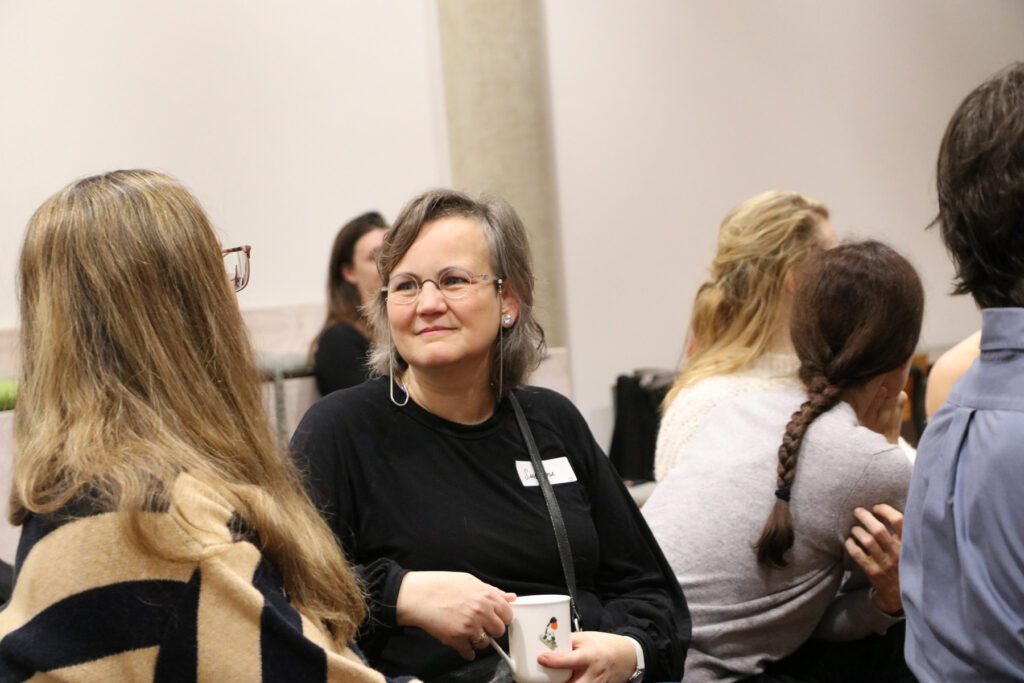 Two women talking in a room about AI