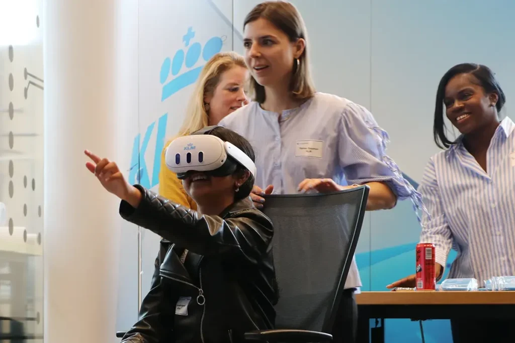 youngster with AI glasses and tutors behind her in a workshop
