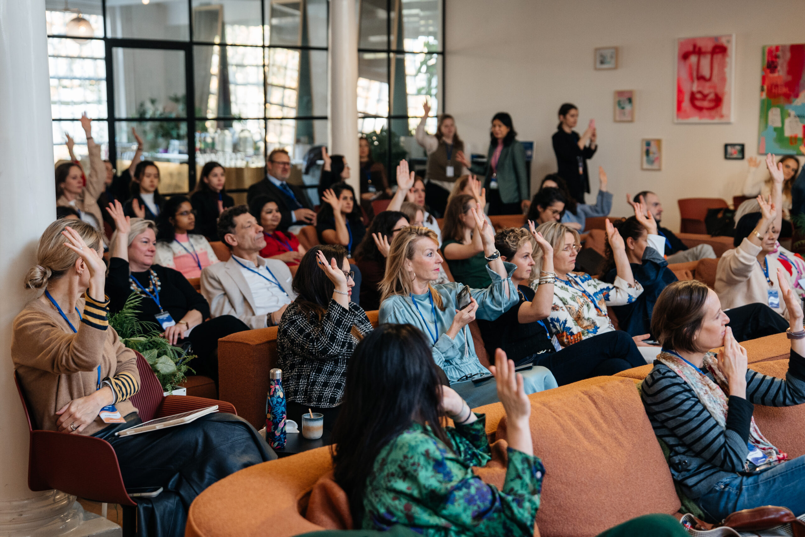 Engaged audience raising hands during a session at the AI4ALL Summit